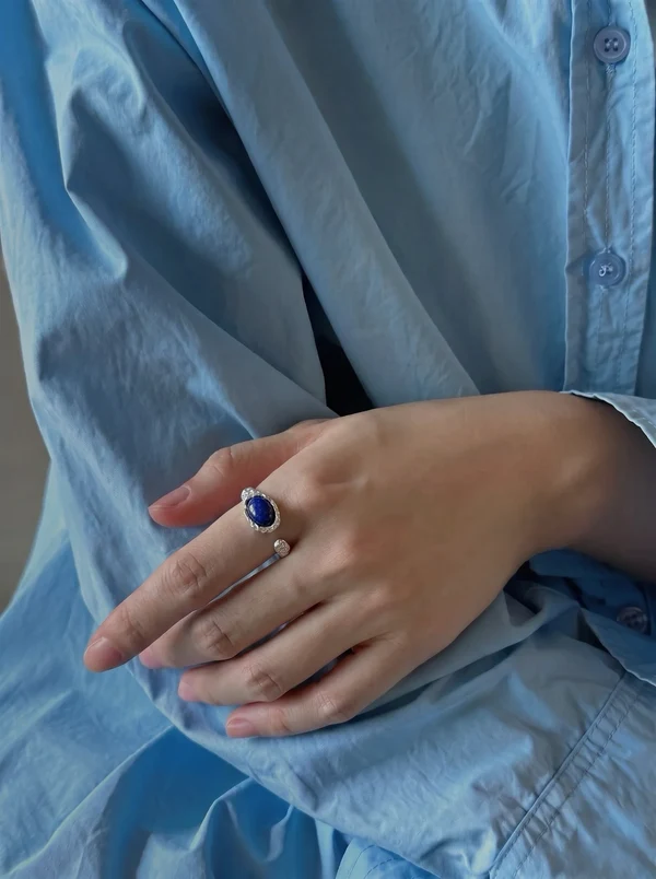 A lapis lazuli ring styled with a light blue shirt